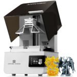 Anycubic Photon P1 resin 3D printer with open cover next to printed resin figurines